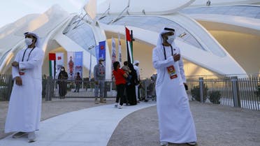 Staff members welcome visitors at the UAE pavilion at the Expo 2020, in the Gulf emirate of Dubai, on December 2, 2021. (AFP)