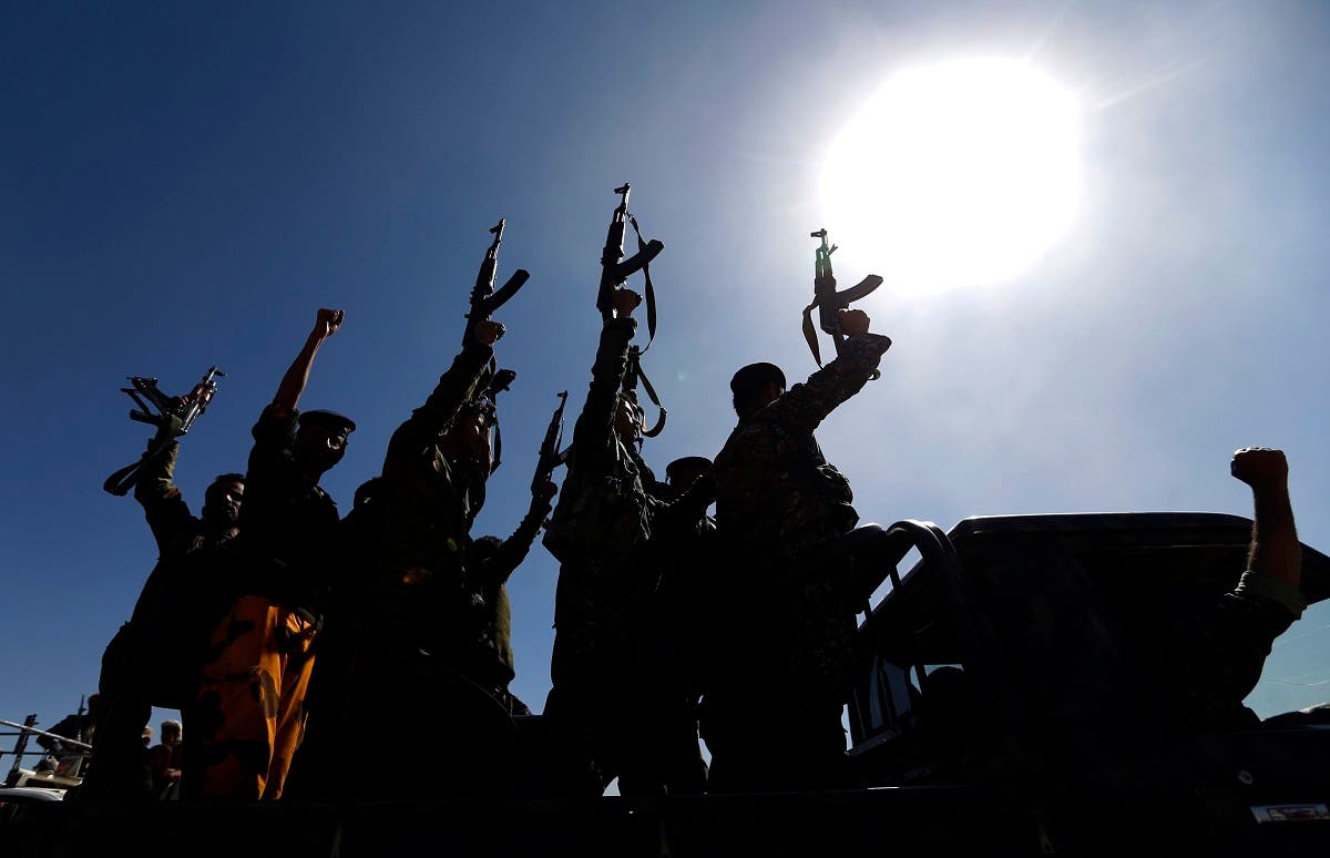 Newly recruited Houthi fighters chant slogans as they ride a military vehicle. (File Photo: AFP)