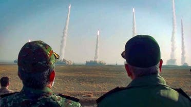 This handout photo provided by Iran's Revolutionary Guard Corps (IRGC) official website via SEPAH News on January 15, 2021, shows the head of Iran's Revolutionary Guard Corps Hossein Salami (R) watching a launch of missiles during a military drill in an unknown location in central Iran. (AFP)