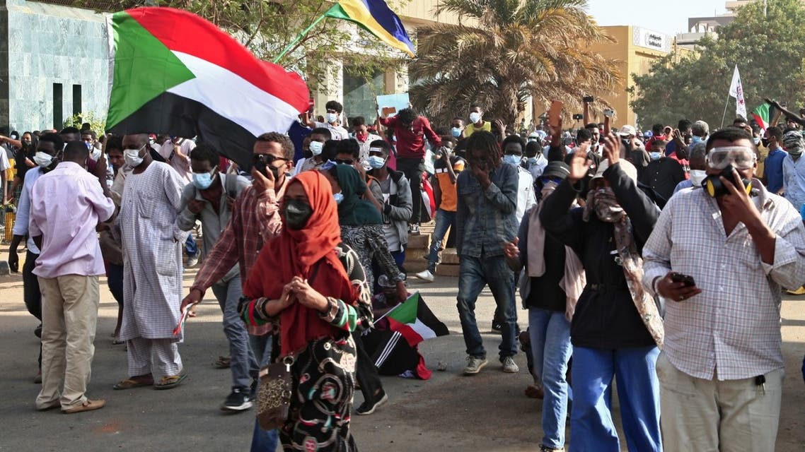Sudanese demonistrators rally to mark three years since the start of mass demonstrations that led to the ouster of strongman Omar al-Bashir, near the Presidential palace in the capital Khartoum on December 19, 2021. (AFP)