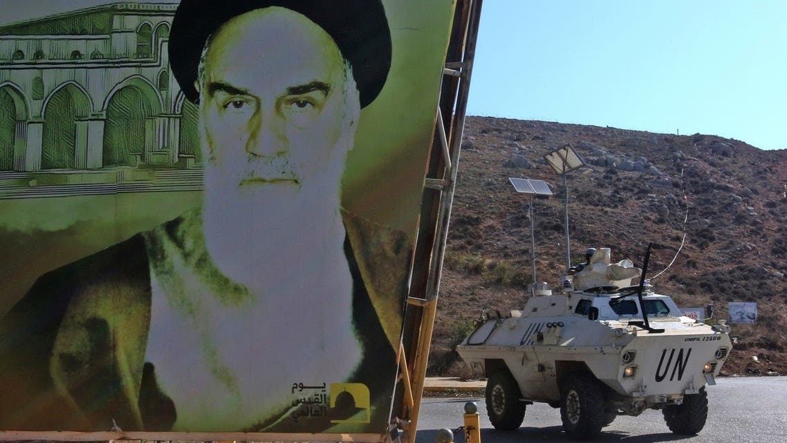 An armored UNIFIL personnel carrier is pictured next to a large poster of Iran’s Ayatollah Ruhollah Khomeini as it patrols along a road in southern Lebanese towns, Nov. 11, 2021. (AFP)
