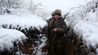 Ukrainian servicemen walk in a trench on their position on the front line with Russia-backed separatists in the Donetsk region, Dec. 18, 2021. (AFP)