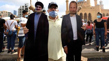 A cut-out of Hassan Nasrallah (L), Hezbollah’s secretary-general, and MP Gebran Bassil in downtown Beirut on Aug. 8, 2020. (AFP)