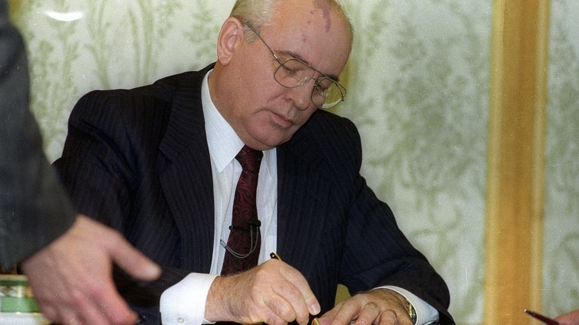 Soviet President Mikhail Gorbachev signs his resignation minutes before a live address on national television on December 25, 1991. (Reuters)