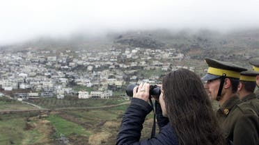 File photo of a Syrian woman looking through a telescope in the Golan Heights village of Ain al-Tineh. (Reuters)