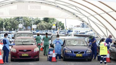 Staff collect COVID-19 swabs from people at a drive-though clinic at Bondi Beach in Sydney on Christmas Day. (AP)