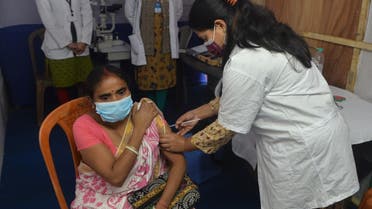A health worker inoculates a woman with a dose of the Covishield vaccine against the Covid-19 coronavirus at a vaccination camp organised at the premises of the 'North Bengal Book Fair' in Siliguri on December 8, 2021. (AFP)