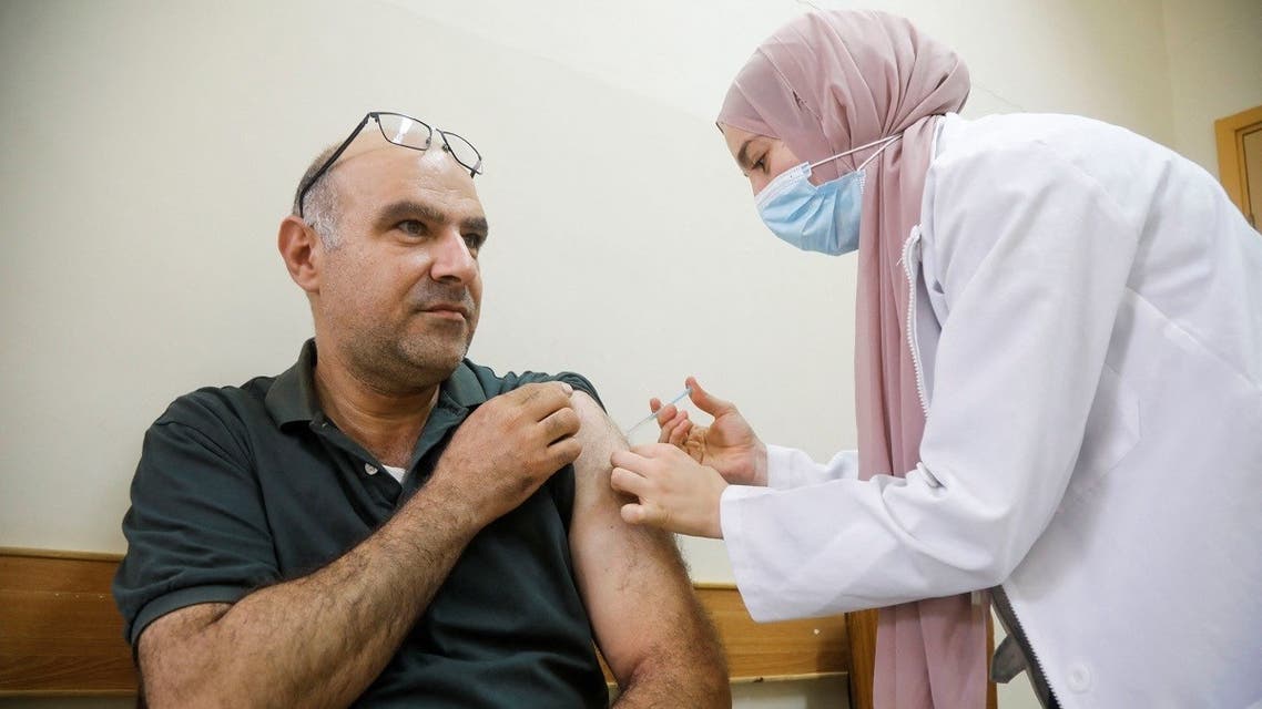 A Palestinian receives a dose of a vaccine to prevent COVID-19 in Jenin in the occupied West Bank on September 15, 2021. (Reuters)