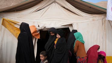Afghan women and children leave the makeshift clinic organized by IFRC in the IDP camp near Qala-e-Naw, Afghanistan, on Dec. 14, 2021. (AP )