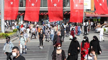 People wearing face masks as a protection against the coronavirus (Covid-19) walk in a street in Ankara on May 21, 2021. (AFP)