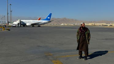 A member of the Taliban stands in the runway at the Kabul airport in Kabul on December 8, 2021. (AFP)