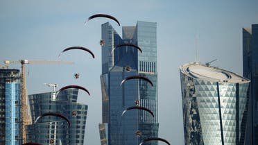 A paragliding display team performs in Qatar's capital Doha as the Gulf state marks its National Day on December 18, 2021. (AFP)