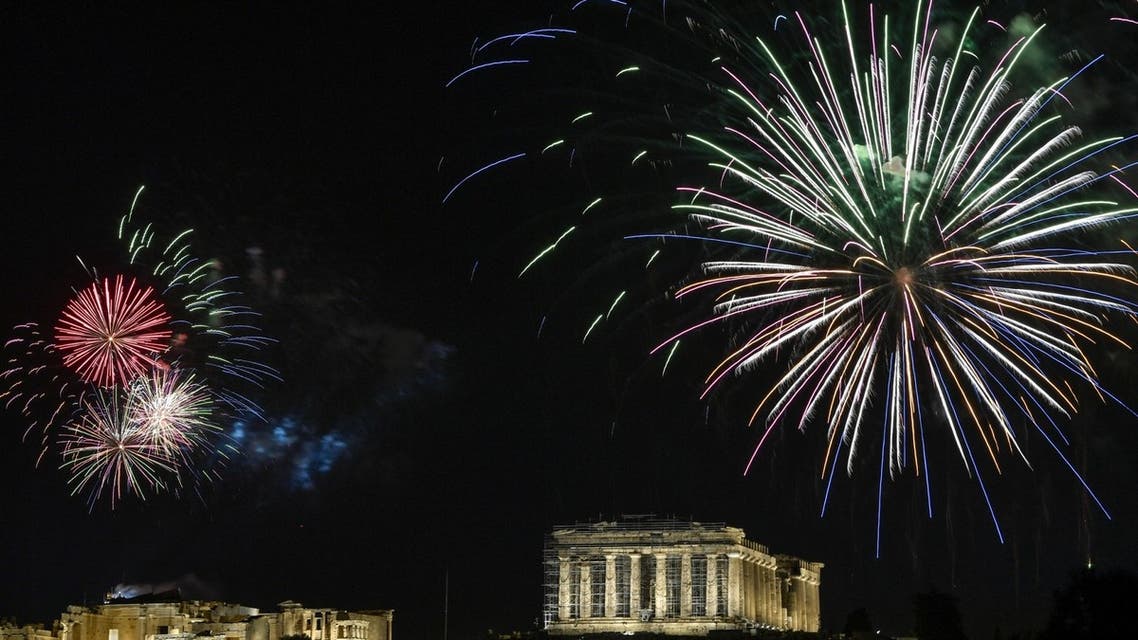 Fireworks explode over the ancient Acropolis in Athens during the new year's celebrations on December 31, 2020. (AFP)
