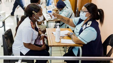 A nurse gets a temperature check before receiving a dose of the Johnson & Johnson vaccine against the COVID-19 coronavirus as South Africa proceeds with its inoculation campaign at the Prince Mshiyeni Hospital in Umlazi, south of Durban on February 18, 2021. (AFP)