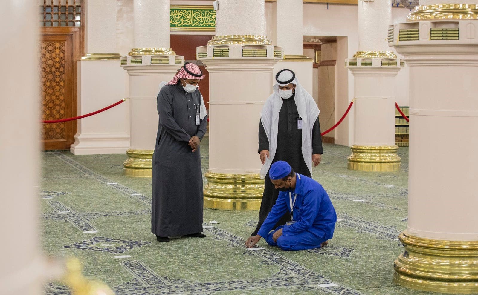 Putting spacing stickers inside the Prophet's Mosque