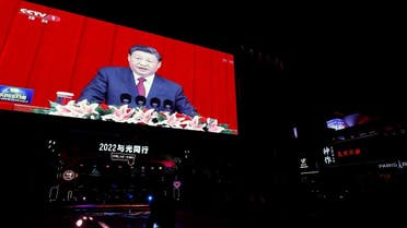 A giant screen displays news footage of Chinese President Xi Jinping delivering a speech, on New Year's Eve at a shopping mall in Beijing, China, on December 31, 2021. (Reuters)