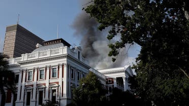 Smoke billows from the roof of a building at the South African Parliament precinct in Cape Town on January 2, 2022, during a fire incident. (AFP)