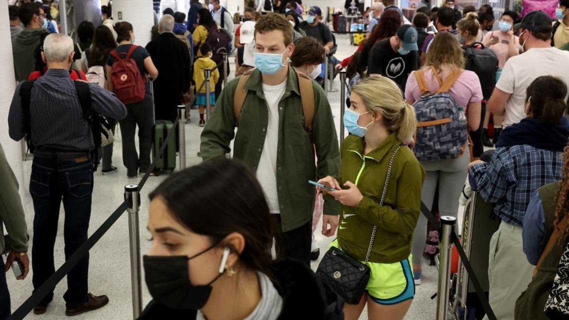 Travelers make their way through Miami International Airport on December 28, 2021 in Miami, Florida. (AFP)