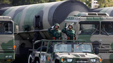 People's Liberation Army (PLA) soldiers salute in front of nuclear-capable missiles during a massive parade to mark the 60th anniversary of the founding of the People's Republic of China in Beijing October 1, 2009. REUTERS/David Gray (CHINA ANNIVERSARY MILITARY POLITICS SOCIETY)
