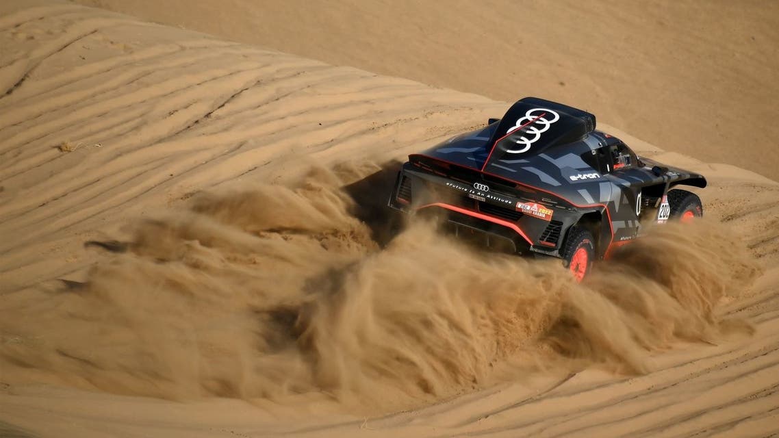 Audi's electric Spanish driver Carlos Sainz of Spain and co-driver Lucas Cruz of Spain compete during the Stage 1A of the Dakar Rally 2022 between Jeddah and Hail, in Saudi Arabia, on January 1, 2022. (Photo by FRANCK FIFE / AFP)