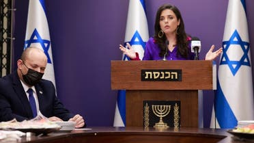 Israeli Interior Minister Ayelet Shaked (R) gives a statement as Prime Minister Naftali Bennett (L) looks on at the Knesset (Parliament) in Jerusalem on July 5, 2021. (AFP)