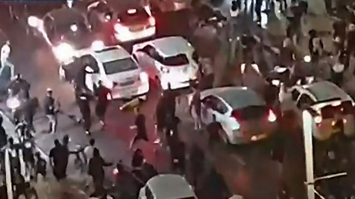 This video grab obtained from a footage released by Kan 11 Public broadcaster on May 12, 2021, shows a far-right Israeli mob attacking who they considered an Arab man, on the seafront promenade of Bat Yam, a town south of Israel's commercial capital Tel Aviv. The footage was aired live on television tonight, leaving many in the country shocked. The images show a man being forcibly removed from his car and beaten by a crowd of dozens until he lost consciousness. Police and emergency services did not arrive on the scene until 15 minutes later, while the victim lay motionless on his back in the middle of the street. / AFP / Kan 11 public proadcaster / - / == RESTRICTED TO EDITORIAL USE - MANDATORY CREDIT AFP PHOTO / HO / KAN 11 PUBLIC BROADCASTER - NO MARKETING NO ADVERTISING CAMPAIGNS - DISTRIBUTED AS A SERVICE TO CLIENTS ==