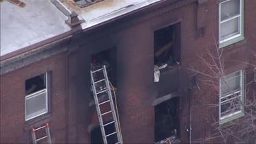 A screen grab from a video shows the Philadelphia Fire Department responding to the fire at the second floor of a three-story rowhouse in the eastern US city of Philadelphia, January 5, 2022. (Reuters)