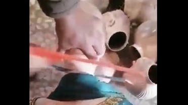 A video image from a clip showing a man sawing the plastic heads off mannequins. (Twitter)