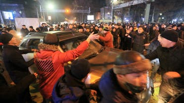 Protesters attend a rally in Almaty on January 4, 2022, after energy price hikes. Police fired tear gas and stun grenades in a bid to break up an unprecedented thousands-strong march in Almaty, Kazakhstan's largest city, after protests that began over fuel prices threatened to spiral out of control. (AFP)