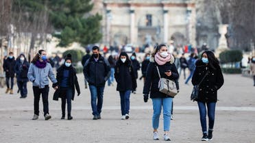 People wearing protective face masks walk in the Tuileries Gardens in Paris amid the coronavirus outbreak in France, on January 5, 2022. (Reuters)