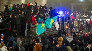 Protesters take part in a rally over a hike in energy prices in Almaty on January 5, 2022. Kazakhstan on January 5, 2022 declared a nationwide state of emergency after protests over a fuel price hike erupted into clashes and saw demonstrators storm government buildings. (AFP)