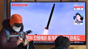 People watch a television news broadcast showing file footage of a North Korean missile test, at a railway station in Seoul on January 5, 2022. (AFP)