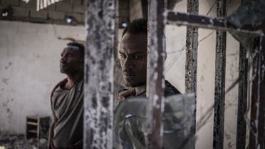A man looks on at a burned warehouse, allegedly looted by Tigray rebels in Shewa Robit, Ethiopia, on December 05, 2021. (AFP)