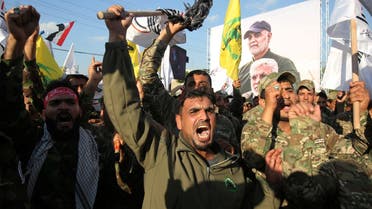Members of the Hashed al-Shaabi paramilitary force chant anti-US slogans during a protest over the killings of Iranian commander Qassem Soleimani and Iraqi paramilitary commander Abu Mahdi Al-Muhandis, on January 6, 2020 in Karrada in central Baghdad. (AFP)