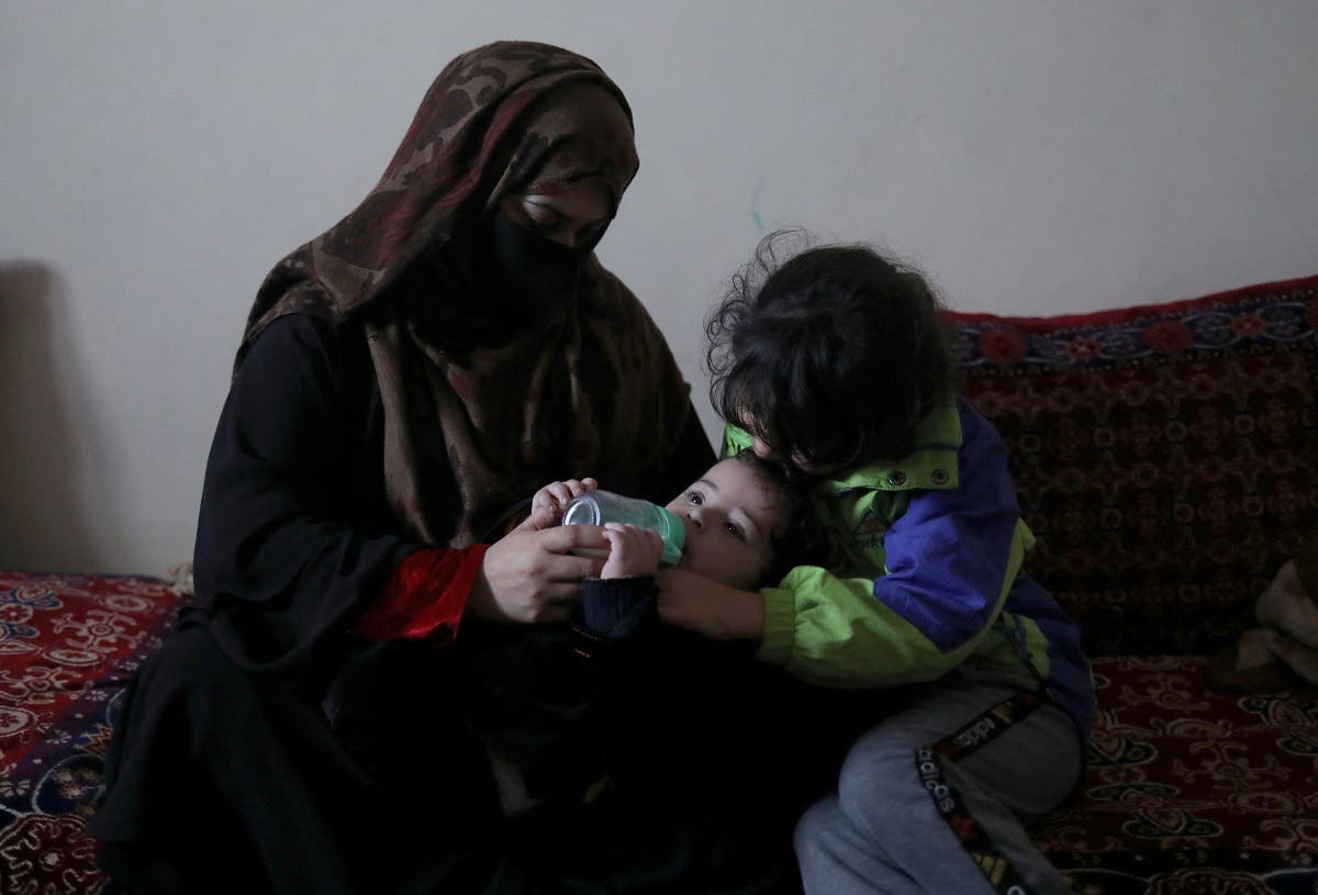 Farima Safi, wife of Hamid Safi, a taxi driver who had found baby Sohail Ahmadi in the airport, feeds Sohail at her house in Kabul, Afghanistan, January 7, 2022. (Reuters)