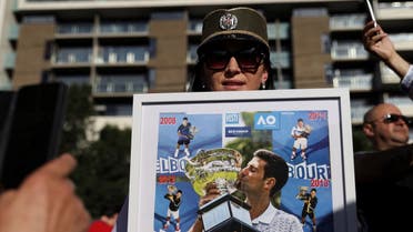 Supporters of Serbian tennis player Novak Djokovic rally outside the Park Hotel, where the star athlete is believed to be held while he stays in Australia, in Melbourne, Australia, on January 9, 2022. (Reuters)