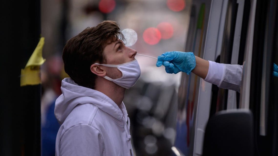A man receives a nasal swab during a test for Covid-19 at a street-side testing booth in New York on December 17, 2021. (AFP)