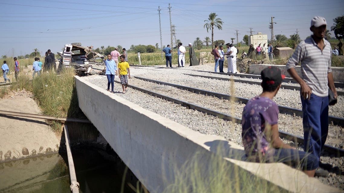 Egyptians gather around the railway track where a pickup truck collided with a train in al-Karnak village in the Luxor governorate in Upper Egypt, some 750 kms south of the Egyptian capital Cairo, on October 29, 2019. (AFP)