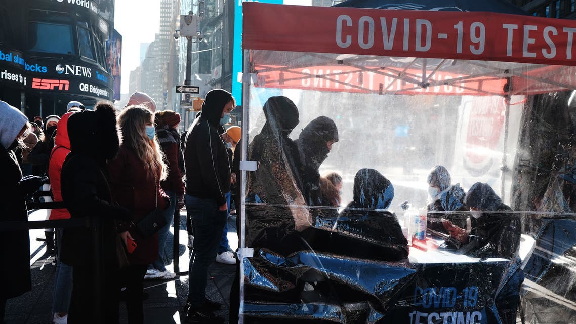 People wait in long lines in Times Square to get tested for Covid-19 on December 20, 2021 in New York City. New York City, which was initially overwhelmed by the Covid pandemic, has once again seen case numbers surge as the new omicron variant becomes dominant. Positivity rates in the city now stand at 8.41% with hospitalizations down slightly. Spencer Platt/Getty Images/AFP (Photo by SPENCER PLATT / GETTY IMAGES NORTH AMERICA / Getty Images via AFP)