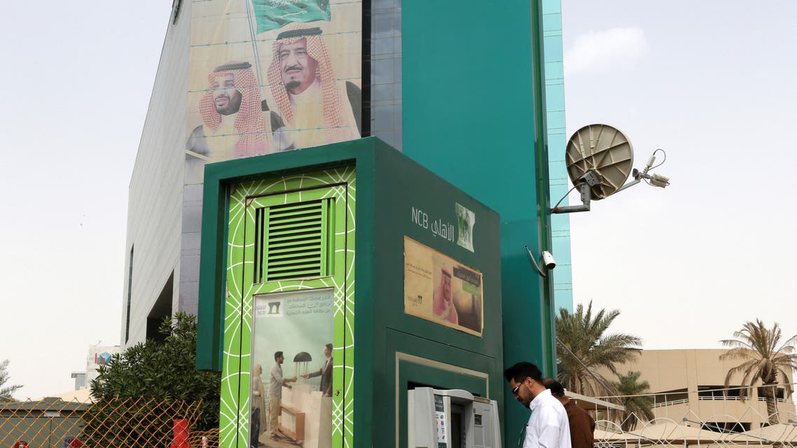 A man withdraws money from an ATM outside the Saudi National Commercial Bank (NCB), after an outbreak of coronavirus, in Riyadh, Saudi Arabia, March 18, 2020. (Reuters)
