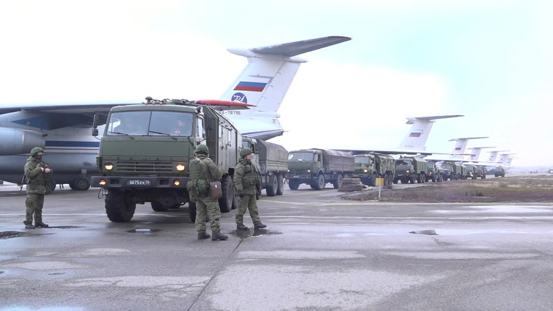 Russian service members and military vehicles are seen upon arrival at Almaty airport, as part of a peacekeeping mission of the Collective Security Treaty Organisation, in Almaty, Kazakhstan, in this still image from video released by Russia's Defence Ministry January 9, 2022. Russian Defence Ministry/Handout via REUTERS ATTENTION EDITORS - THIS IMAGE HAS BEEN SUPPLIED BY A THIRD PARTY. MANDATORY CREDIT. NO RESALES. NO ARCHIVES.