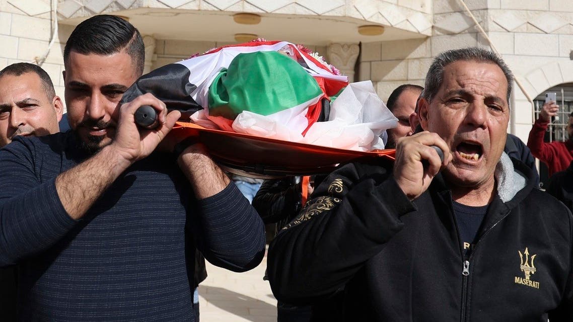 Palestinian relatives mourn during the funeral of Omar Abdalmajeed Asaad, 80, who was found dead after being detained and handcuffed during an Israeli raid, in Jaljuliya village in the Israeli-occupied West Bank, on January 13, 2022. (AFP)