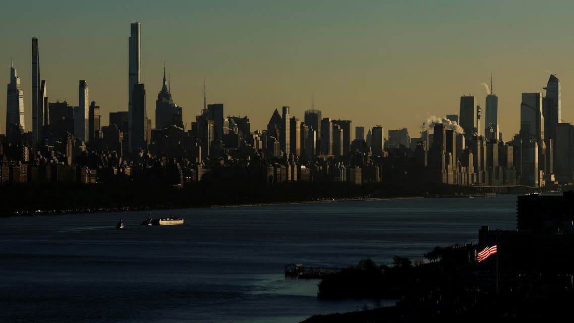 A barge makes way down the Hudson River near sunset past the skyline of the west side of Manhattan during very cold weather in New York, January 11, 2022. (Reuters)