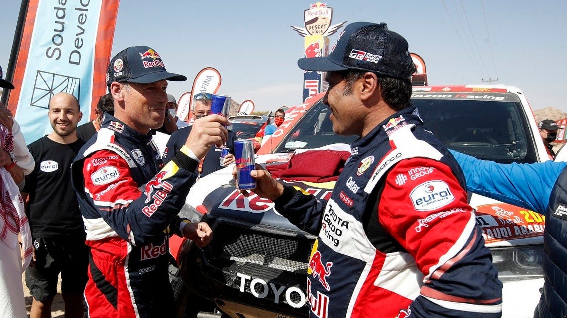 Winners of the car category, Toyota Gazoo Racing’s Nasser Al-Attiyah and co-driver Matthieu Baumel celebrate after stage 12. (Reuters/Hamad I Mohammed)