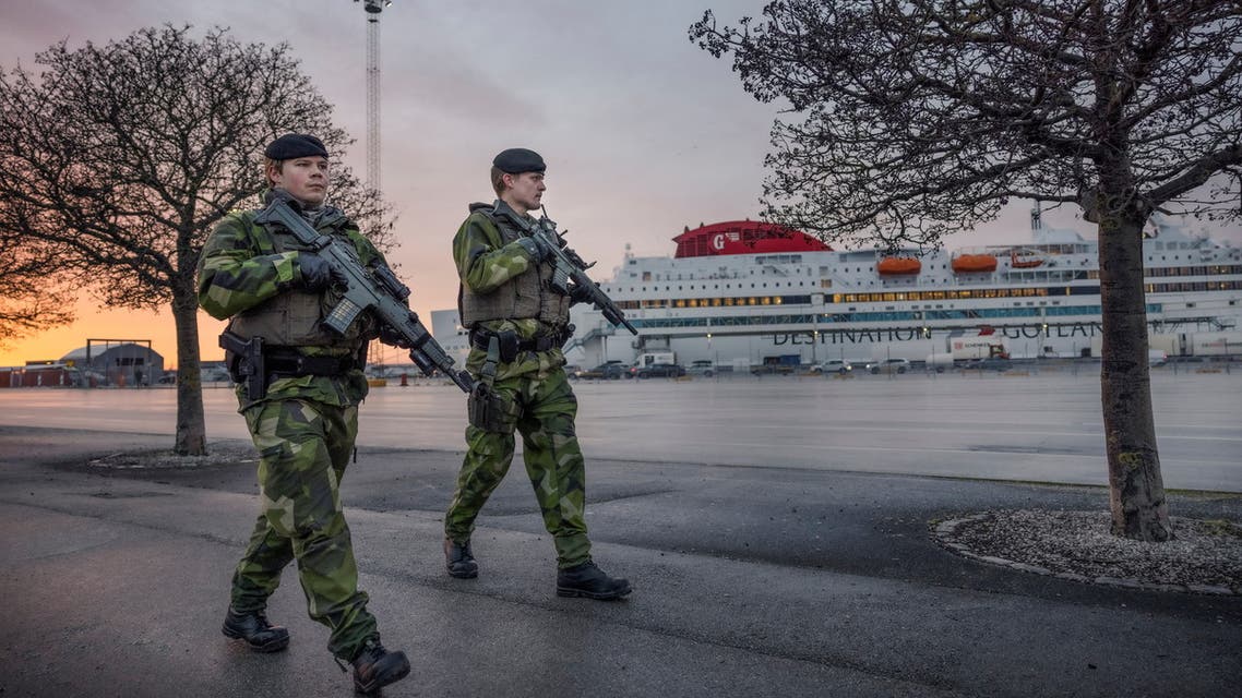 Soldiers from Gotland's regiment patrol Visby harbour, amid increased tensions between NATO and Russia over Ukraine, on the Swedish island of Gotland, Sweden, 13 January 2022. Picture taken January 13, 2022. TT News Agency/Karl Melander via REUTERS ATTENTION EDITORS - THIS IMAGE WAS PROVIDED BY A THIRD PARTY. SWEDEN OUT. NO COMMERCIAL OR EDITORIAL SALES IN SWEDEN.