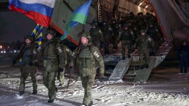 This handout picture taken and released by the Russian Defense Ministry on January 14, 2022 shows Russian troops leaving a military cargo plane upon landing in Ivanovo after completing their mission in Kazakhstan. (Russian Defense Ministry/AFP)