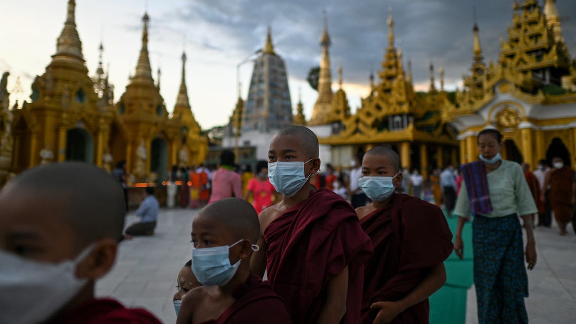 Monks visit Shwedagon Pagoda during the Thadingyut festival, which is held on the full moon day of the Burmese lunar month of Thadingyut, in Yangon on October 20, 2021. (Photo by Ye Aung THU / AFP)