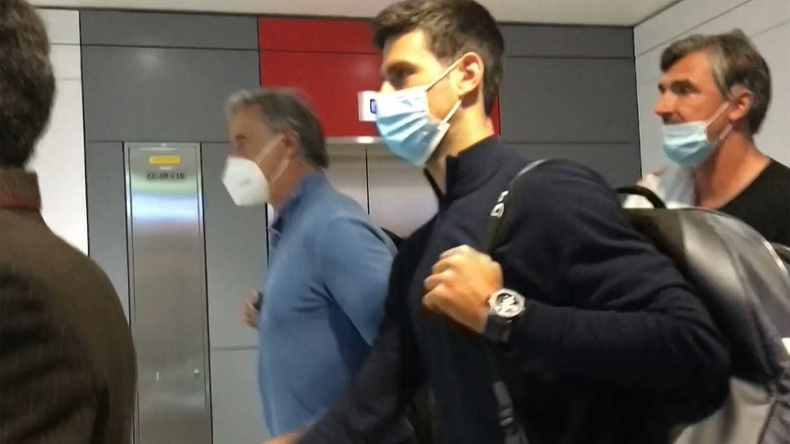This screen grab from AFPTV shows Serbia's Novak Djokovic (C) as he disembarks from his plane at the airport in Dubai on January 17, 2022, after losing a legal battle on January 16 in Australia to stay and play in the Australian Open tennis tournament over his coronavirus vaccination status. (Photo by AFPTV / AFP)