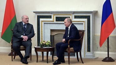 Russian President Vladimir Putin (R) greets Belarus' President Alexander Lukashenko at the Konstantin Palace presidential residence in Strelna, outside St. Petersburg, on December 29, 2021. (AFP)