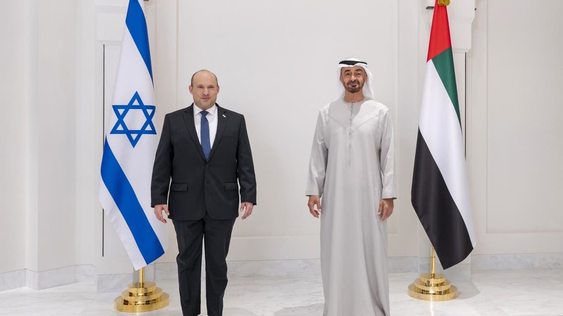 A handout picture released by the United Arab Emirates' Ministry of Presidential Affairs shows Abu Dhabi's Crown Prince Sheikh Mohammed bin Zayed Al-Nahyan (R) posing for a picture with Israeli Prime Minister Naftali Bennett during their meeting in the Emirati capital Abu Dhabi, on December 13, 2021. (AFP)